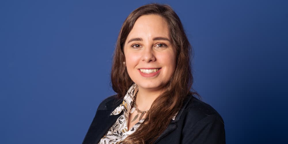 Portrait of a smiling woman against blue background
