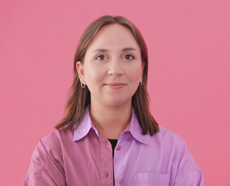 Woman smiling with pink background
