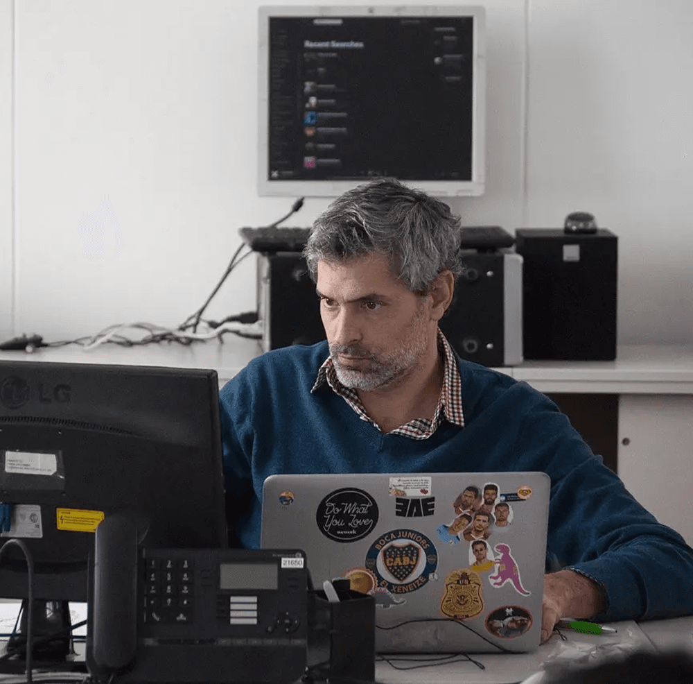 Man working on computer and laptop in office