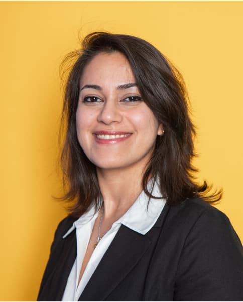 Woman smiling yellow background