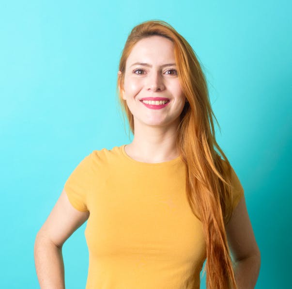 woman standing and laughing - blue background