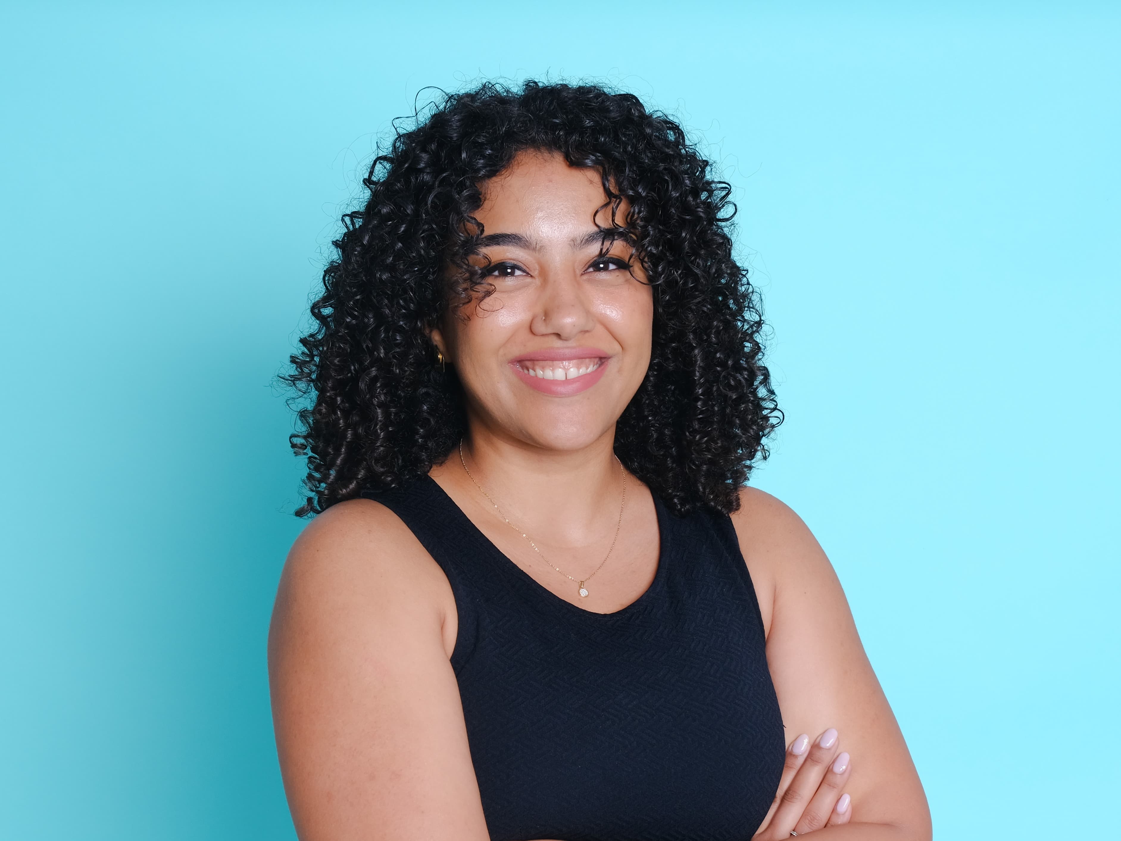 Woman with curly hair against blue background