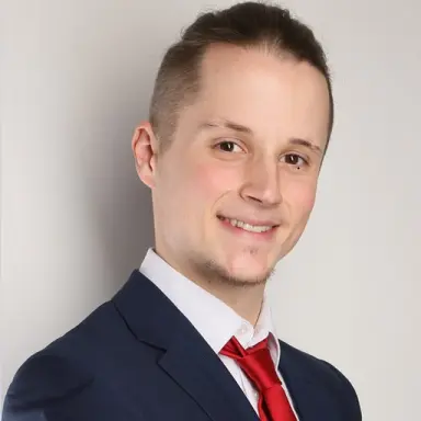 Portrait of a young man in a suit and red tie