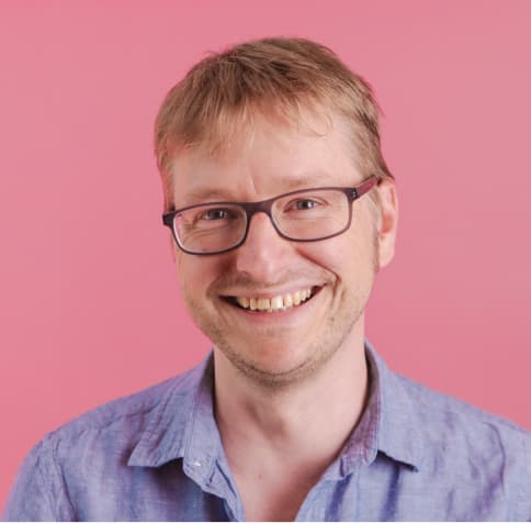 Man smiling pink background