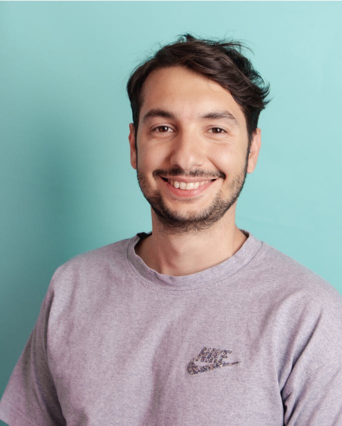 Man smiling turquoise background