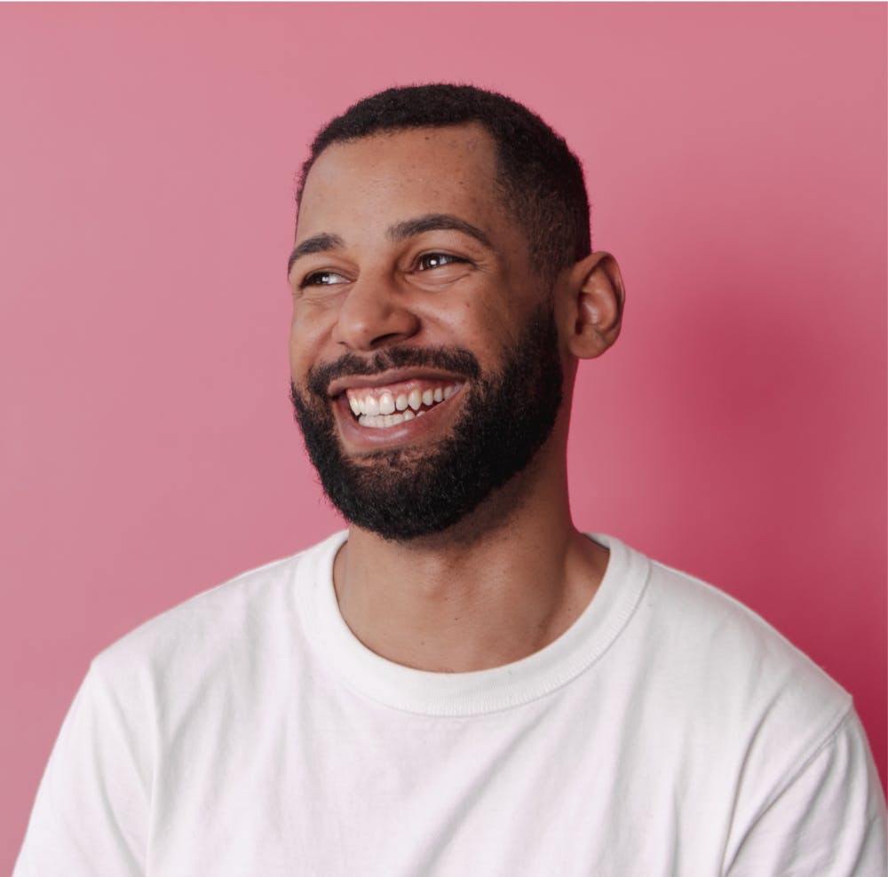 Man with smiling, pink background